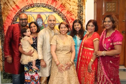 A photograph of a West Indian family wearing traditional Indian clothing